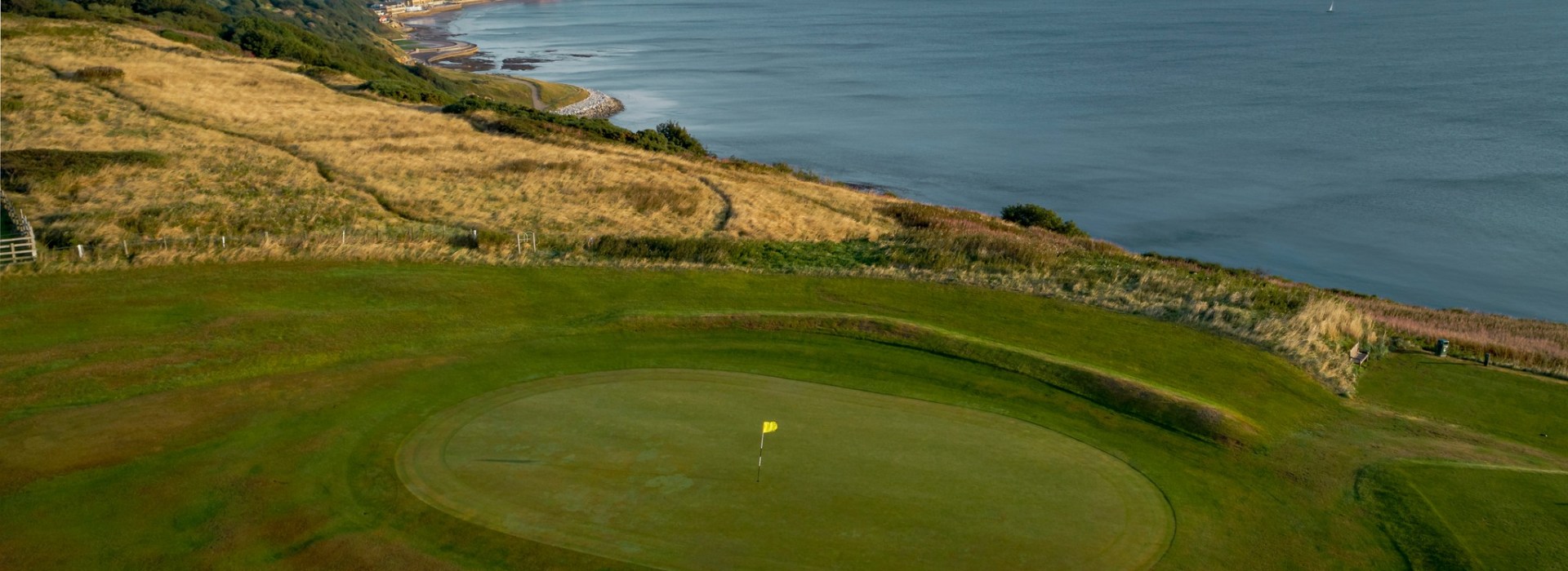 Golf course hole overlooking the sea